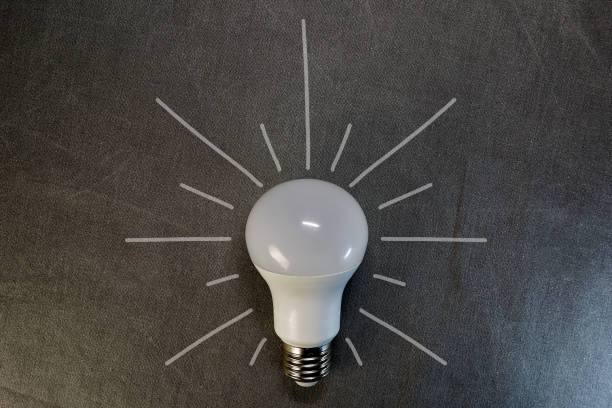 istock top view of LED light bulb on gray background with copy space, flat lay 1152335981