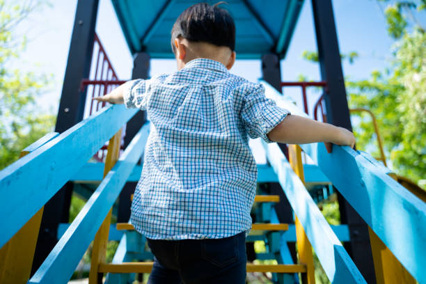 istock Little boy climbing on stair to play slider 1152337669