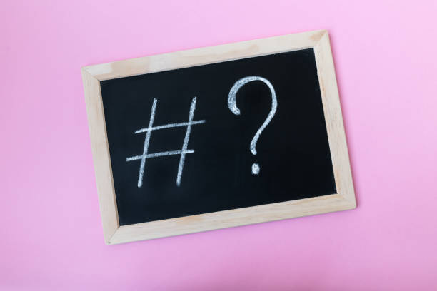 Blackboard with a chalk hashtag and a question mark written on it.