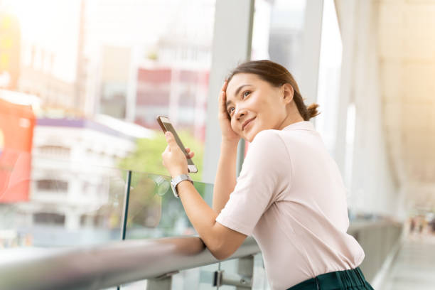 istock Happy woman using smart phone in the city 1152339451