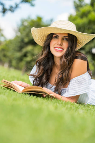 istock Woman reading in the park 1152339551