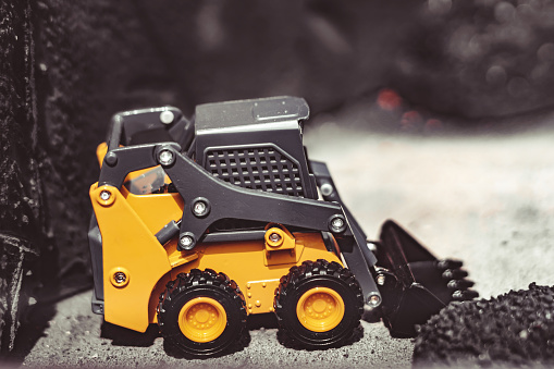 toy tractor in the scenery of coal mining