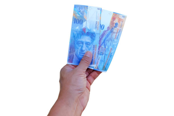 istock Swiss francs banknotes hold in male hand 1152341721