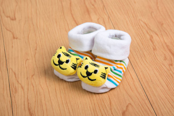 istock baby socks in wooden background 1152342559