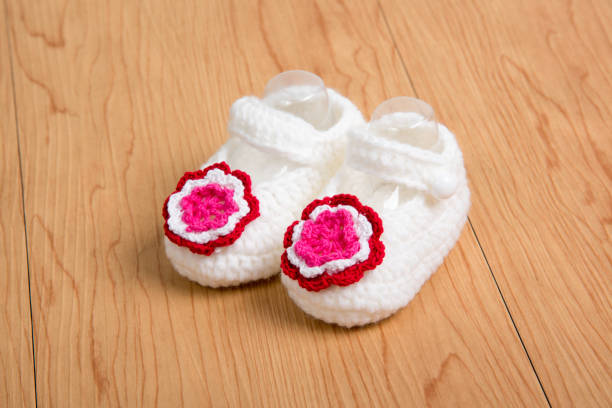 istock baby socks in wooden background 1152342561
