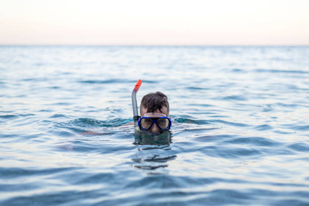 istock Young man swiming in a diving mask. 1152343544
