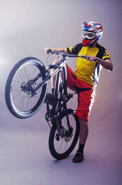 istock Professional cyclist wearing a helmet on a gray background. 1152344992