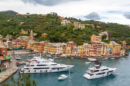 Portofino Italy. 04-29-2019.  Boats  and colored houses at Portofino, Italy