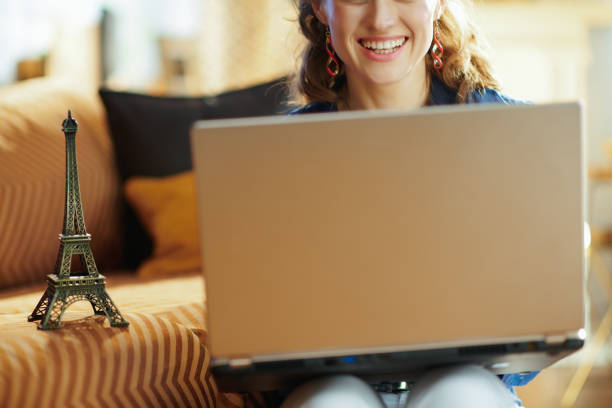 istock Closeup on woman with souvenir of eiffel tower using laptop 1152346078