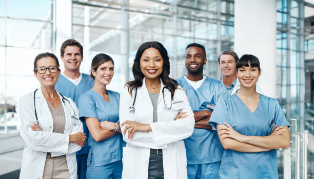 Together we save more lives than we would individually Portrait of a group of medical practitioners standing together in a hospital lab coat photos stock pictures, royalty-free photos & images