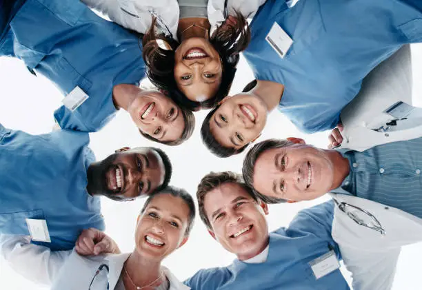 Cropped shot of a group of healthcare workers looking down at the camera