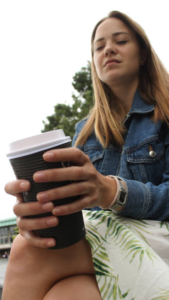 istock Young woman on her coffee break in the park 1152347527