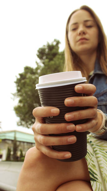 istock Young woman on her coffee break in the park 1152347547