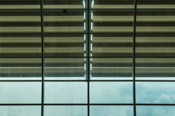 istock glass office building facade with big blinds 1152349640