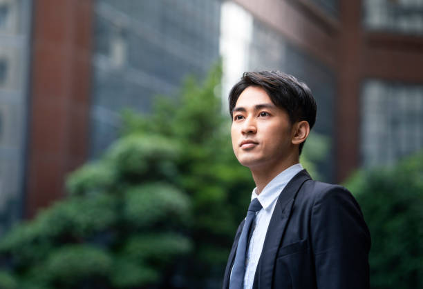 istock Businessman standing against office building 1152350032