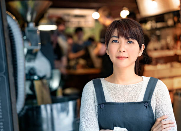 istock Confident female owner standing with arms crossed 1152350168