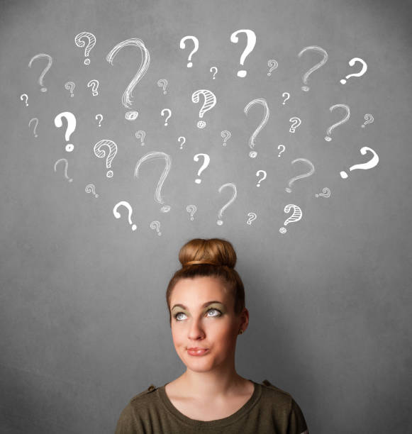 istock Young woman with question marks above her head 1152351218
