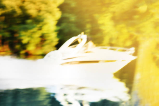 Blurred background with a fast moving white jet ski. Concept of active vacation. Golden hour