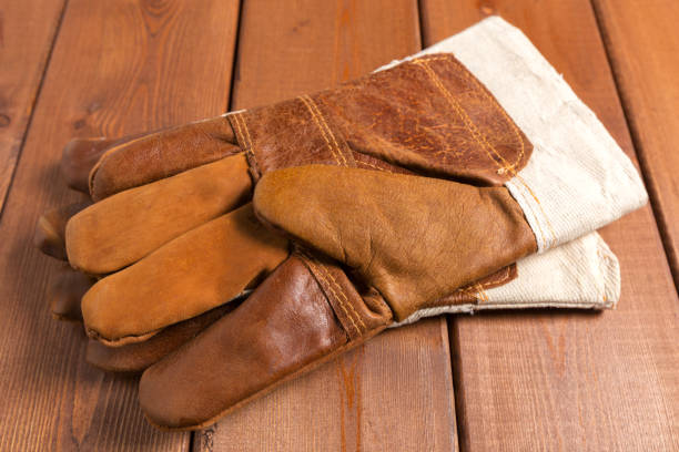 istock Construction gloves on a wooden background. close up 1152359539