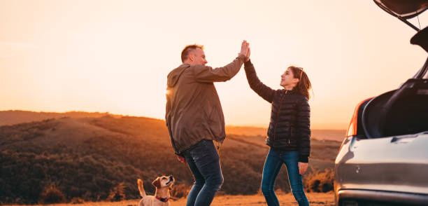 istock Father and daughter giving high five at camping on a hill 1152364458