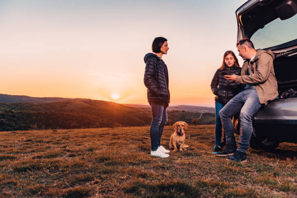 istock Family with dog camping at hill during sunset 1152365093