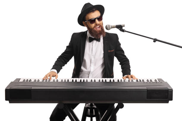 istock Man with sunglasses and a beard playing a digital piano and singing on a microphone 1152365177