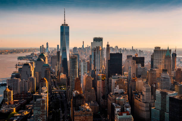 the majesty of manhattan island taken from a helicopter above the downtown area at a golden hour - lower manhattan imagens e fotografias de stock