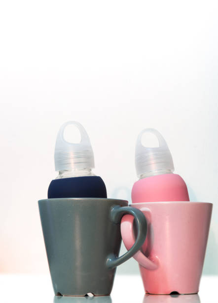 istock pink and blue couple cups on white background 1152365772