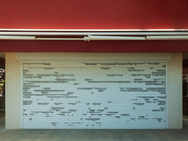 istock Garage entrance closed grungy rolling shutter with peeling paint 1152369662