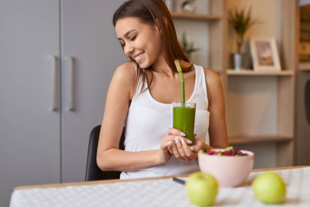 istock Smiling lady with detox drink 1152370546