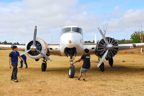 Cuyo Island, Palawan Province, Philippines - March 8, 2008: Volpar Beechcraft cargo plane with open engine under maintenance at the airport