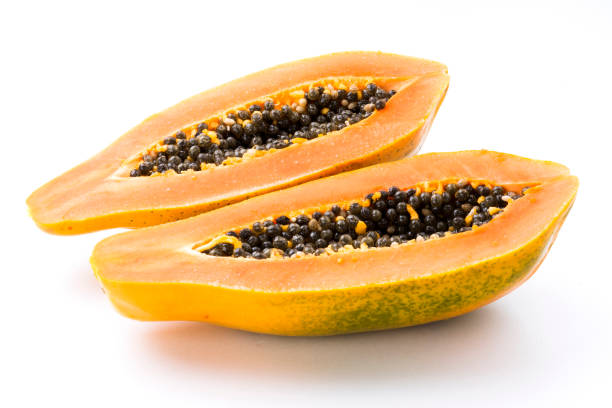 ripe papaya with half isolated on the white background. ripe papaya with half isolated on the white background. papaya stock pictures, royalty-free photos & images