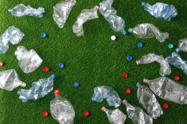 istock The concept of recycling plastic and environmental protection. Pet preforms for plastic bottles on the green grass. Artificial turf. 1152374143