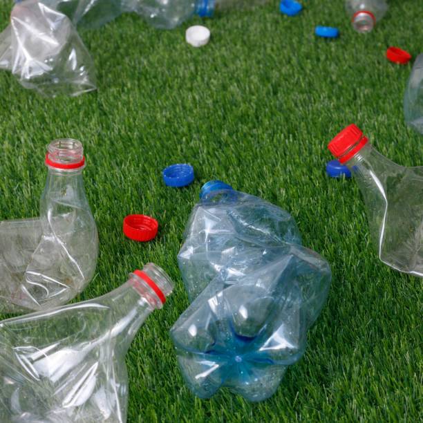 istock The concept of recycling plastic and environmental protection. Pet preforms for plastic bottles on the green grass. Artificial turf. 1152374153