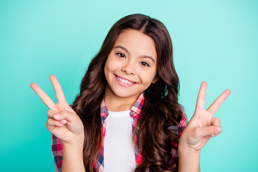 portrait of nice pretty sweet lady little enjoy weekend rest relax make v-sign travel summer spring feel satisfied funny dressed checked shirt modern clothing isolated green background.