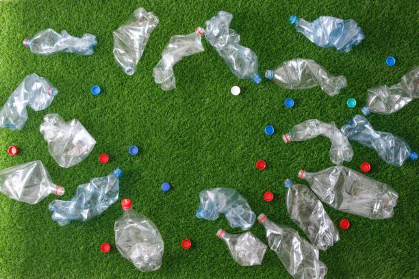 istock The concept of recycling plastic and environmental protection. Pet preforms for plastic bottles on the green grass. Artificial turf. 1152374859