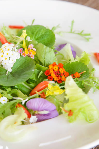 istock Fresh spring greens and edible flowers salad 1152378847