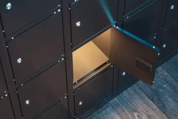 Black safe deposit boxes with switched-on light. Safety closets. 3d rendering. one safe deposit box is opened