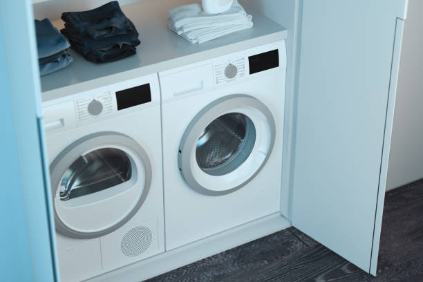 istock Washing and dryer machines with detergent and clothes above. 3d rendering. 1152380102