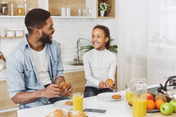 istock afro child girl and her father having breakfast 1152380121