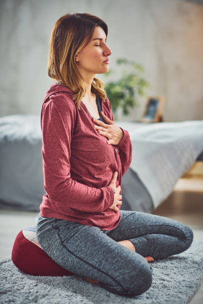 istock Woman practicing breathing in bedroom. 1152380583