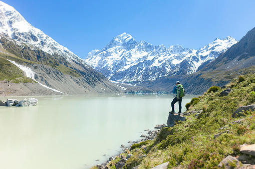 A young men enjoying the beautiful view of glacier , New Zealand