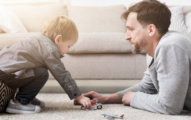 istock Father and little boy playing with toys 1152383099