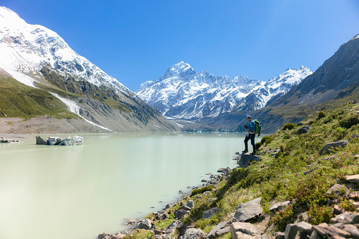A young men enjoying the beautiful view of glacier , New Zealand