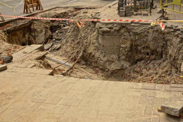 istock large pit on the sidewalk by the road 1152383299