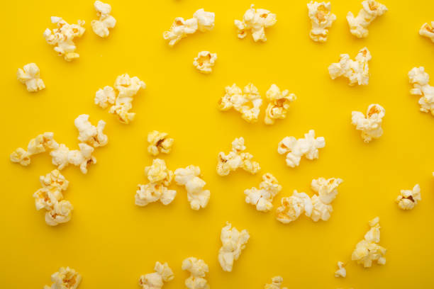 istock Popcorn pattern, texture on a yellow background. Top view, entertainment, movie 1152383585