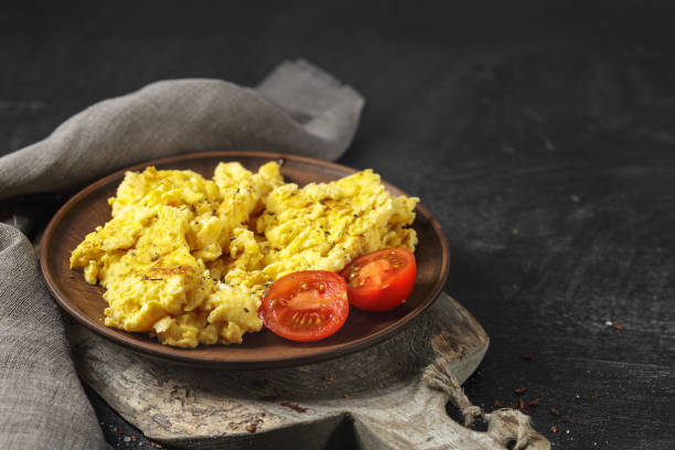istock Fried eggs in a frying pan with cherry tomatoes 1152384762