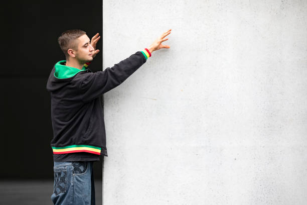 Young Adult Man Reaching for Copy Space.