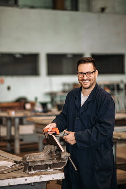 istock Portrait of a positive manual worker at workshop. 1152387877