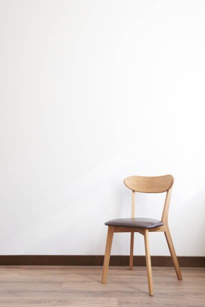 istock Wooden chair over white wall interior 1152389097